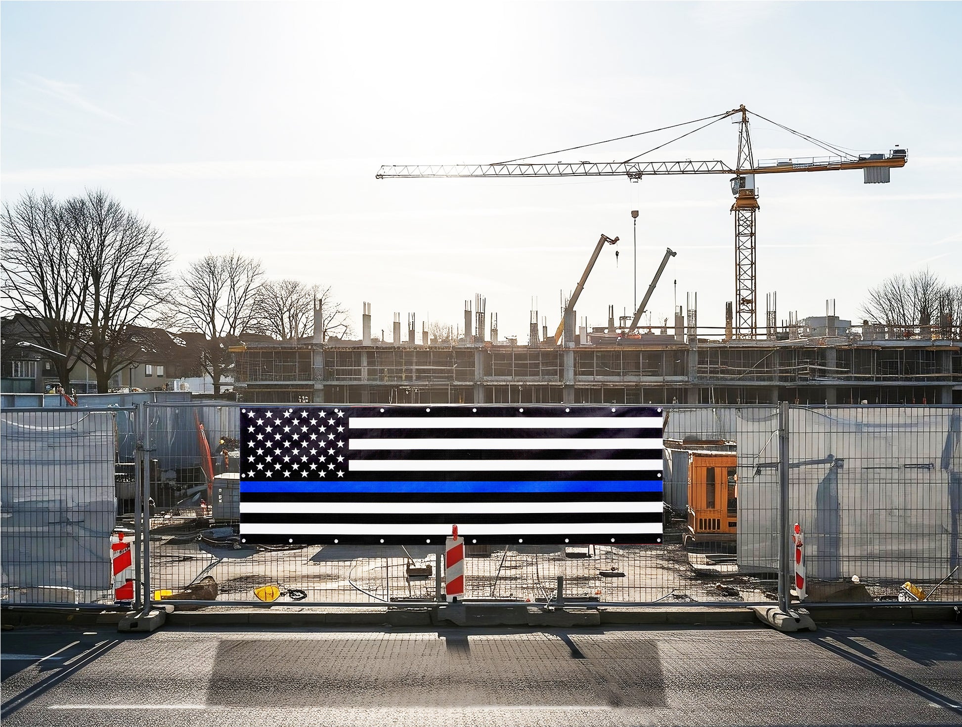 A thin blue line flag is displayed at a construction site, representing solidarity with police and first responders.  