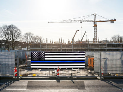 A thin blue line flag is displayed at a construction site, representing solidarity with police and first responders.  